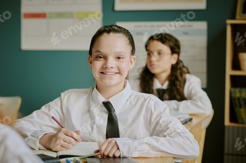 Preview: Portrait of Smiling Schoolgirl Sitting in Classroom