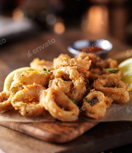 Preview: crispy fried calamari rings with marinara dipping sauce and lemon