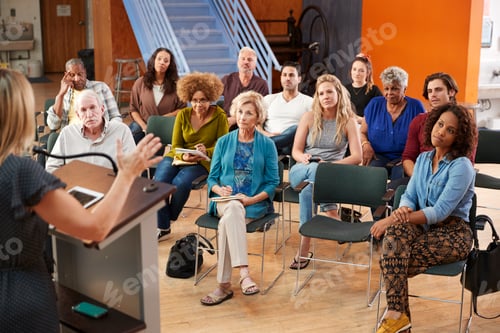 Preview: Group Attending Neighborhood Meeting Listening To Speaker In Community Center