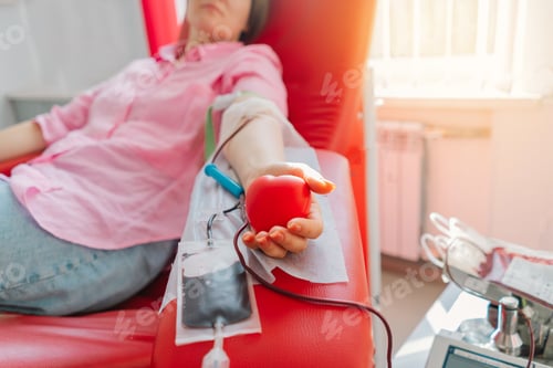 Preview: Young woman making blood donation in hospital. Blood donation.