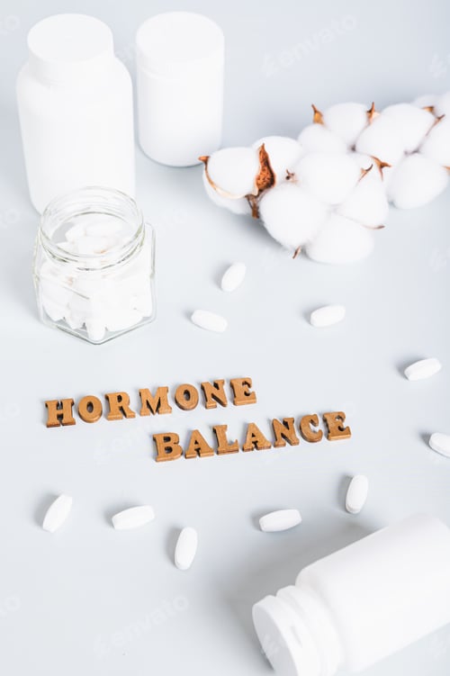 Preview: Hormonal balance concept, pills, bottles and text on blue background vertical view