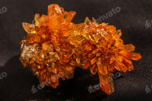 Preview: natural creedite crystal formation with orange color in sunlight
