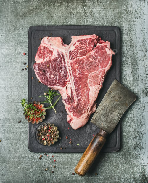 Preview: Fresh raw beef uncooked t-bone steak with spices on board