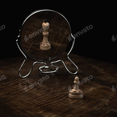 Preview: Vertical shot of a chess pawn on a wooden table and a mirror reflecting it as a chess queen