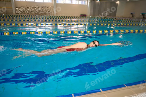 Preview: Young athlete practicing front crawl stroke in water