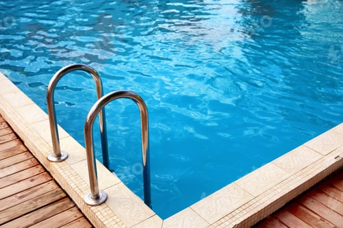 Preview: Modern swimming pool with step ladder at resort