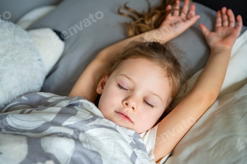Preview: Cute little girl sleeping with a toy in her bed, nap concept