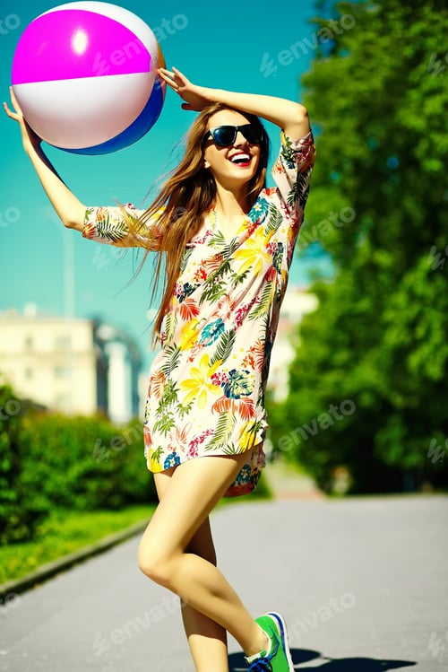 Preview: Beautiful young woman posing outdoors in summer clothes