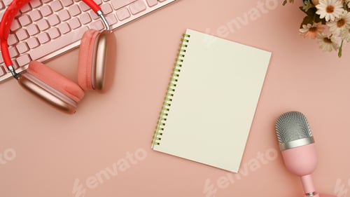 Preview: Above view wireless headphone, microphone for podcasts and notepad on pink background.