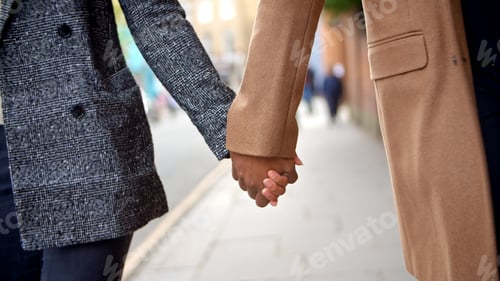Preview: Close Up Of Couple Holding Hands Walking Along City Street