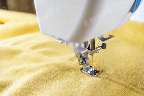 Preview: Modern Sewing Machine With Yellow Velours Fabric Close Up