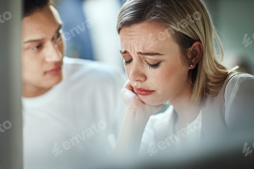 Preview: Shot of a young businessman consoling an upset colleague as they sit together in the office