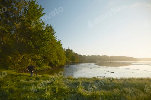 Preview: Man photographing coast at dusk, Puget Sound, Washington State, USA