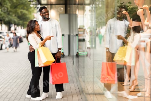 Preview: Black lady hugging man pointing at mall window