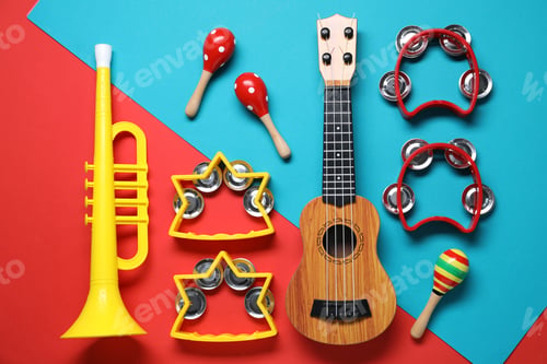 Preview: Flat lay composition with different toy musical instruments on color background