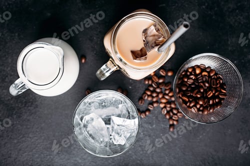 Preview: Cold iced coffee with ingredients: ice cubes, milk, coffee beans