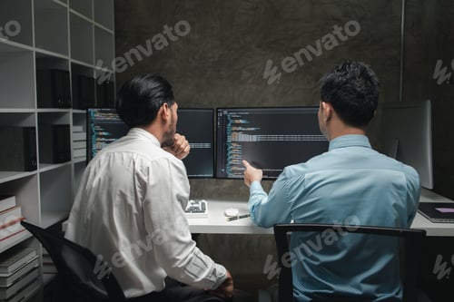 Preview: Group of programmers brainstorm together to write programs on the computer, designing programs to me