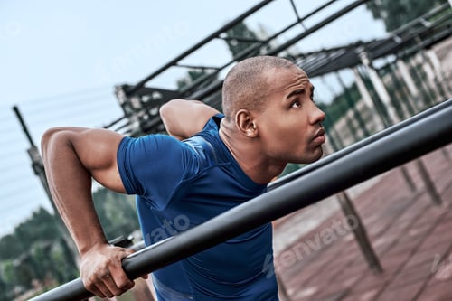 Preview: An african man is exercising at open air gym