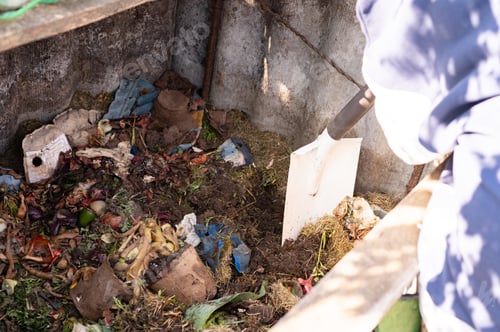 Preview: Composting process in a wooden bin with organic waste and shovel. Learn About Composting Day