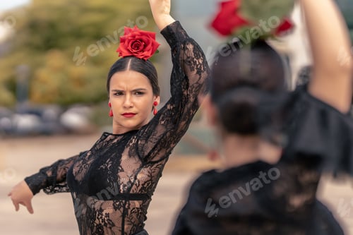 Preview: spanish young girl dancing flamenco with red earrings, red rose and lips painted red