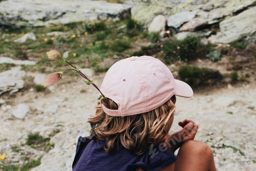Preview: Child wearing a cap with a flower in it