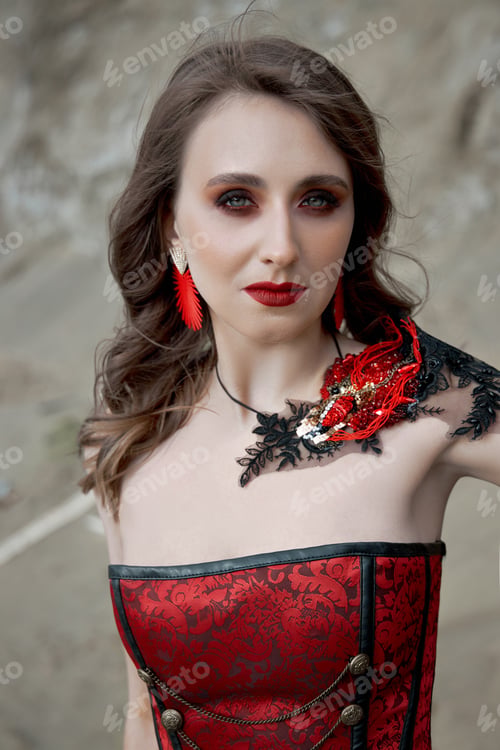 Preview: Beautiful anime woman in the sand. Red corset on the girl's body. Bright red makeup on the face