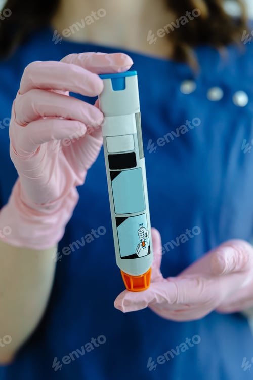 Preview: Doctor is demonstrating auto-injector syringe as an emergency treatment for allergic reaction