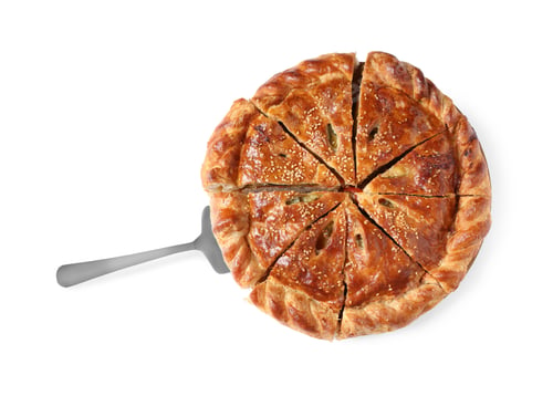 Preview: Cut delicious homemade pie and server isolated on white, top view