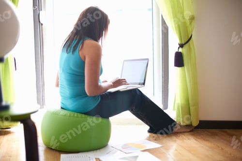 Preview: Woman using laptop at home