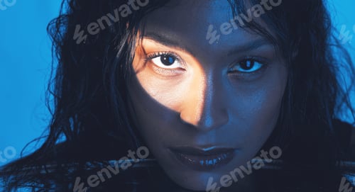 Preview: Beauty, cosmetics and portrait of a model with a light reflection on her face in the studio. Spotli