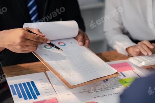 Preview: Group businessmen point to the material for the meeting, working together to plan to develop and sol