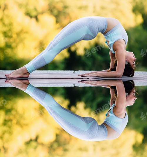 Preview: Pretty woman doing yoga exercises in the park