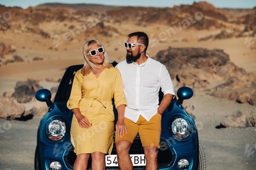 Preview: a woman and a man wearing glasses in a convertible car on a trip to the island of Tenerife. The