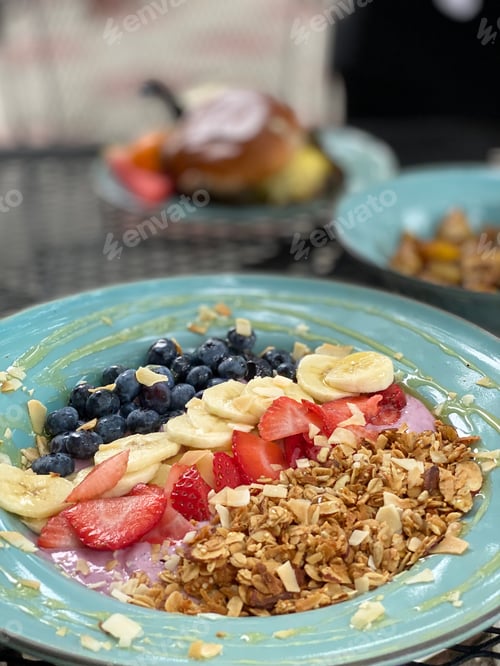 Preview: Plates of healthy breakfast foods on table outdoors at a restaurant