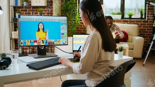 Preview: Asian graphic designer uses editing software for photo retouching