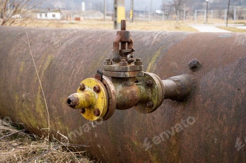 Preview: Vintage meter attached to a metal pipe on the ground