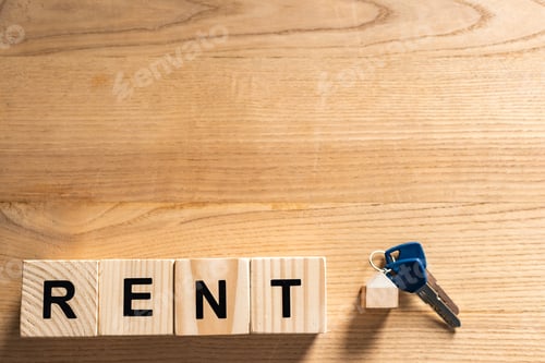 Preview: top view of keys with key chain near cubes with rent lettering on table