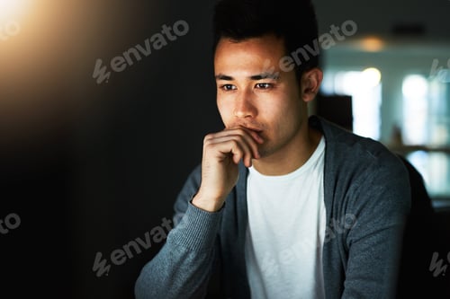 Preview: Working through the night. Shot of a handsome young male programmer working late in his office.