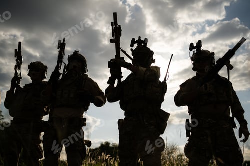 Preview: Soldier holding gun and showing action success or war win, special forces military training concept.