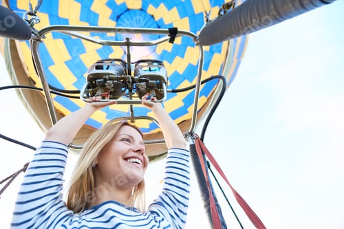 Preview: Caucasian Young Woman Operating Hot Air Balloon Burner during Flight Adventure
