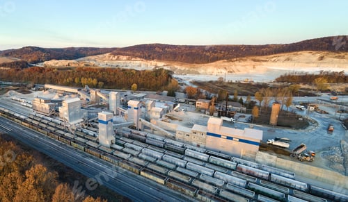Preview: Aerial view of cargo train loaded with crushed stone materials at mining factory. Railway