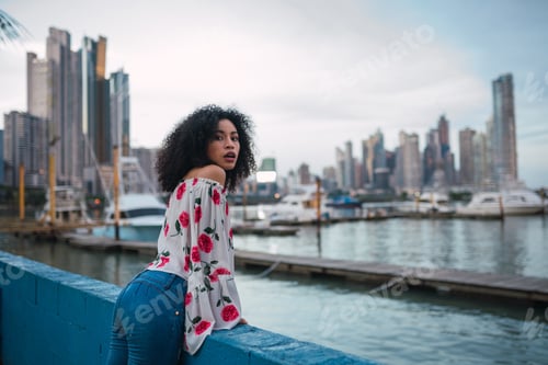 Preview: Ethnic woman on city waterfront