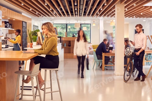 Preview: Interior Of Busy Office Coffee Shop With Businesspeople Working At Tables
