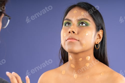 Preview: Applying foundation to young woman