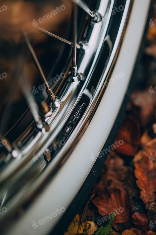 Preview: Vertical selective focus shot of a vintage car wheel in an autumn park