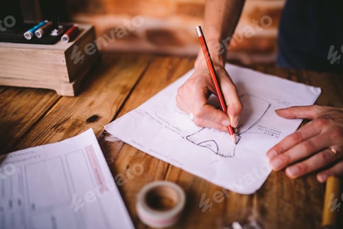 Preview: Fashion Designer Sketching Design on Wooden Desk