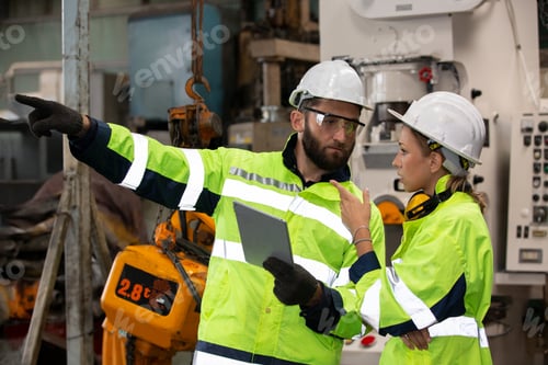 Preview: Portrait woman worker and engineer under inspection and checking production process on factory.