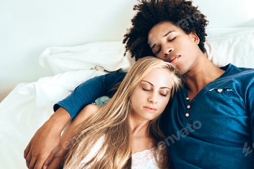 Preview: Young beautiful interracial couple in bed sleeping