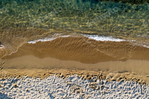 Preview: Aerial view of sandy beach and ocean with waves.