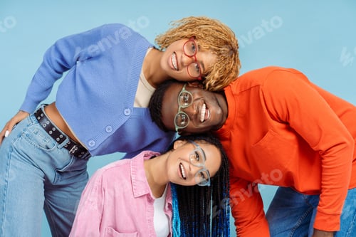Preview: Group of happy stylish African American friends wearing colorful eyeglasses isolated on blue backgro